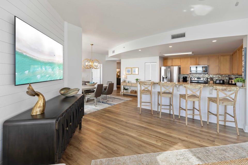 Gather around your spacious kitchen island with friends, enjoying morning coffee or evening cocktails in this bright, open living space.