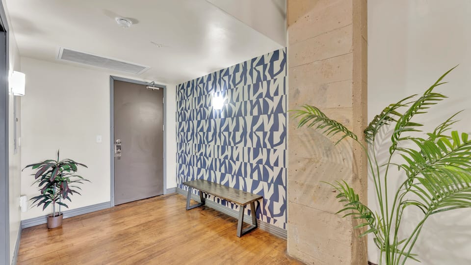 Welcoming entryway with statement wallpaper and industrial details.