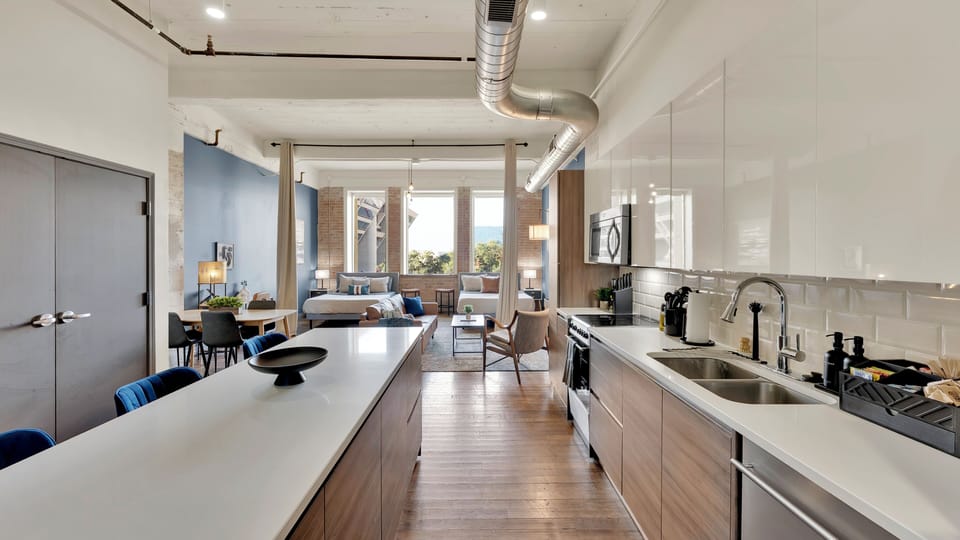 Open industrial downtown Dallas loft with exposed ductwork and seamless open-concept living.