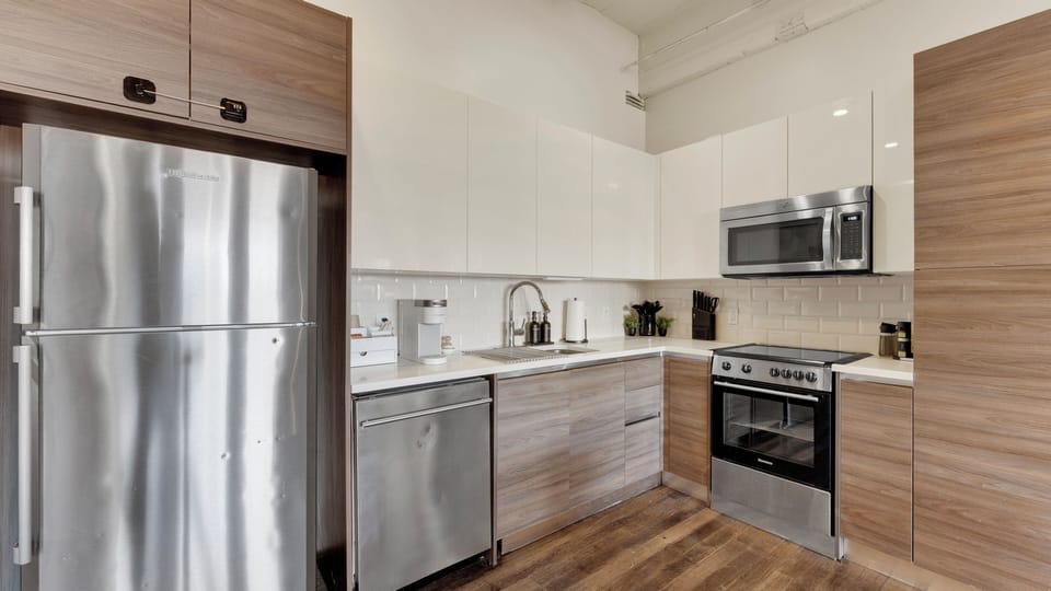 Modern kitchen with full-size stainless steel appliances.