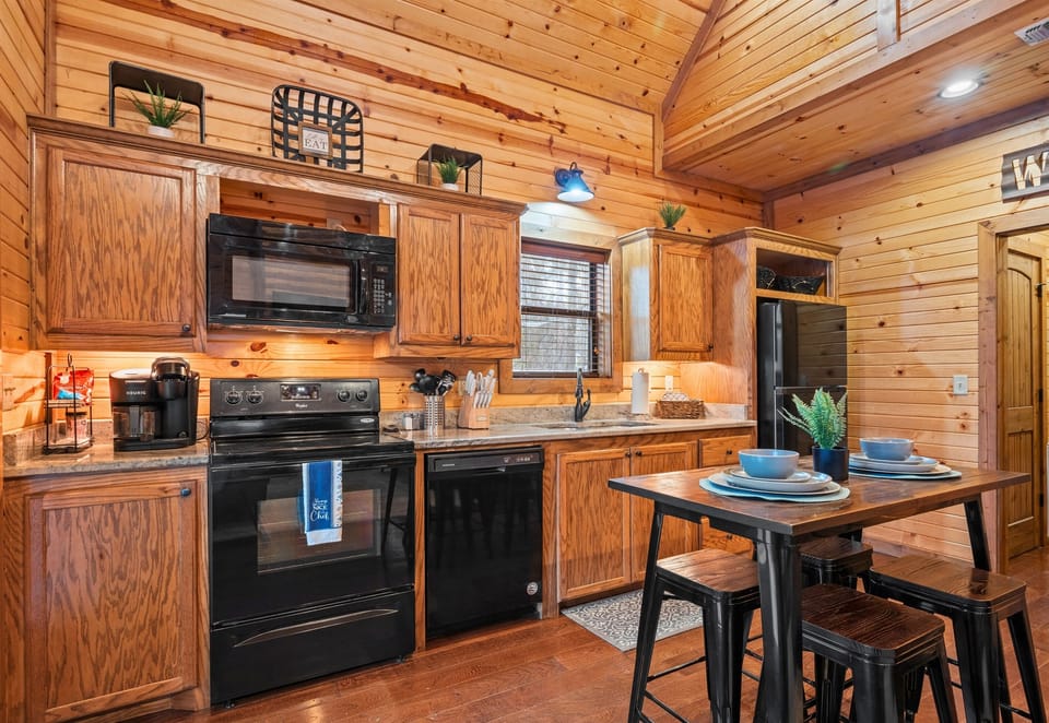 Another view of the kitchen highlights the generous counter space and open layout, giving everyone room to cook, gather, or simply hang out together.