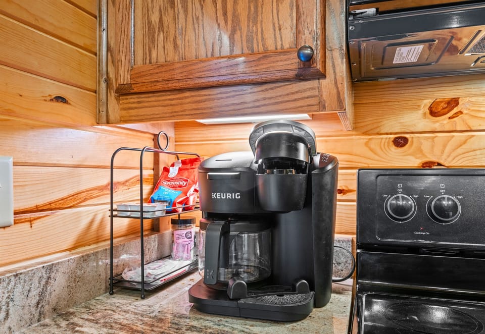 The dedicated coffee station is perfect for slow mornings, letting you enjoy your first cup while taking in the quiet cabin surroundings.