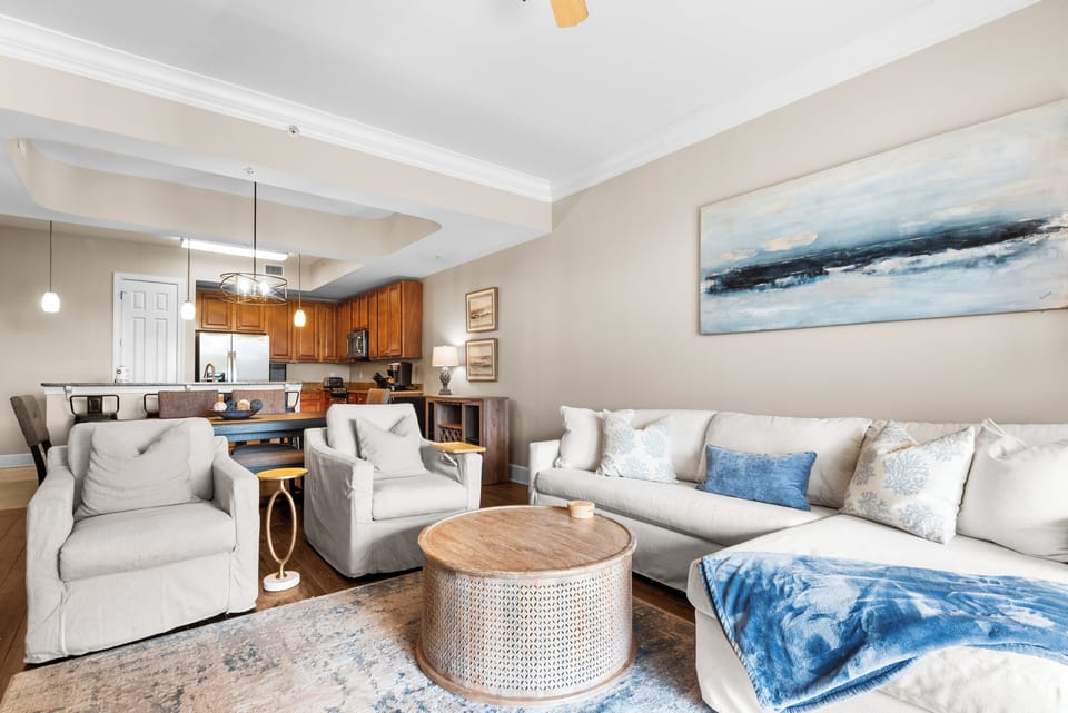 Unwind in this spacious living area where plush seating and coastal artwork create the perfect retreat after exploring.
