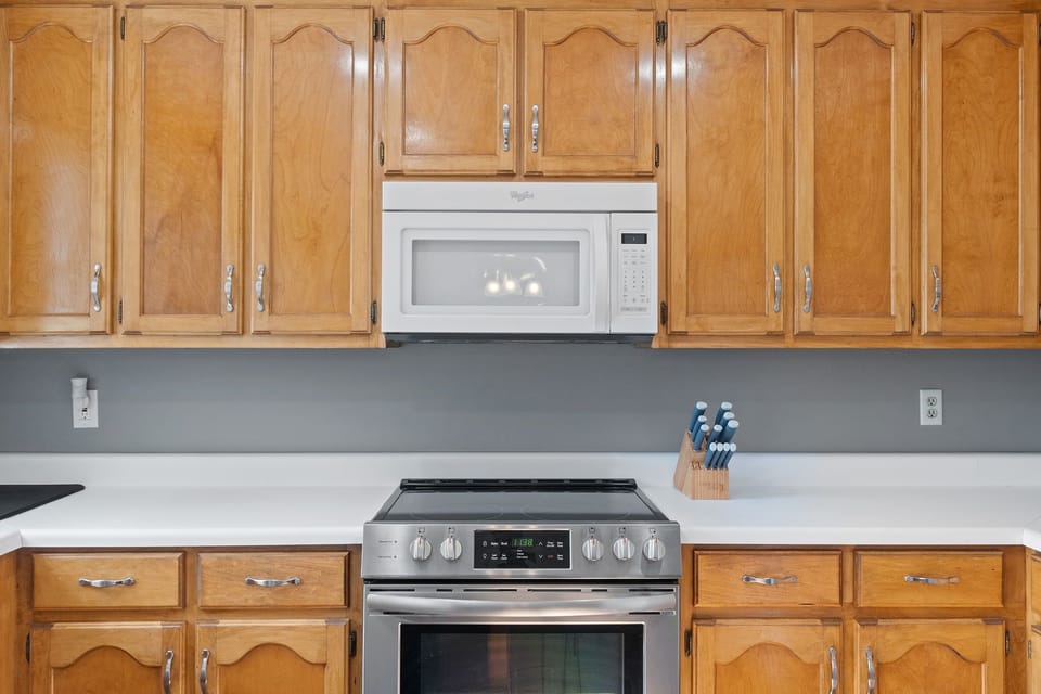 Charming kitchen with everything you need—from stainless steel stove to microwave and more.
