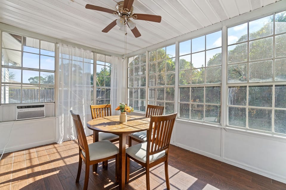Enjoy your morning coffee or a relaxing dinner in this light-filled sunroom. Surrounded by windows and featuring a ceiling fan for added comfort, it’s the perfect spot to unwind and take in the view of the backyard.