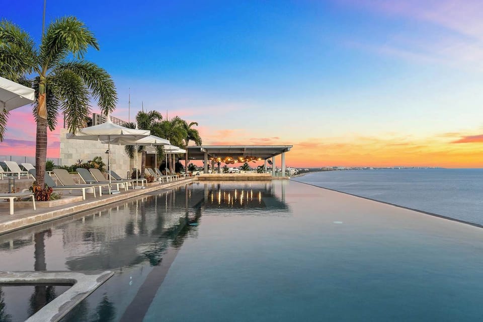 Rooftop infinity pool at sunset 