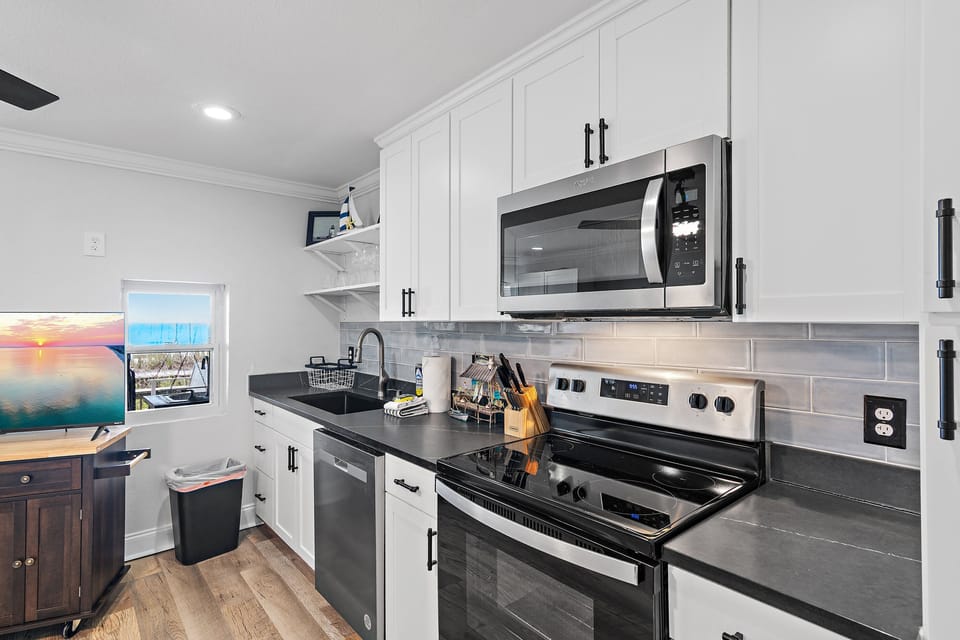 The 1st Floor features another Living Room w/ 50" Smart TV, Pre-Loaded Game Console, Murphy Bed, a Kitchenette, and Patio Access - Great for the Kids or Two Families!