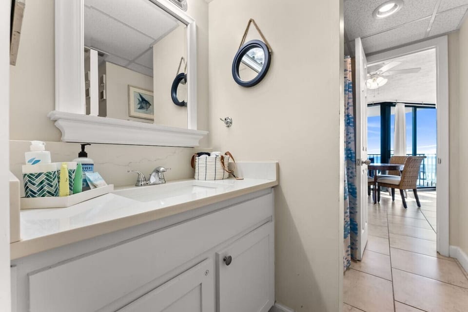 Clean bathroom vanity with storage and fresh coastal accents.