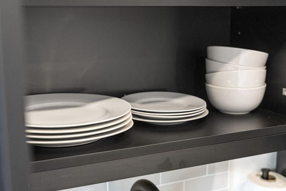 Plates, bowls, mugs, glasses, and utensils—all included.