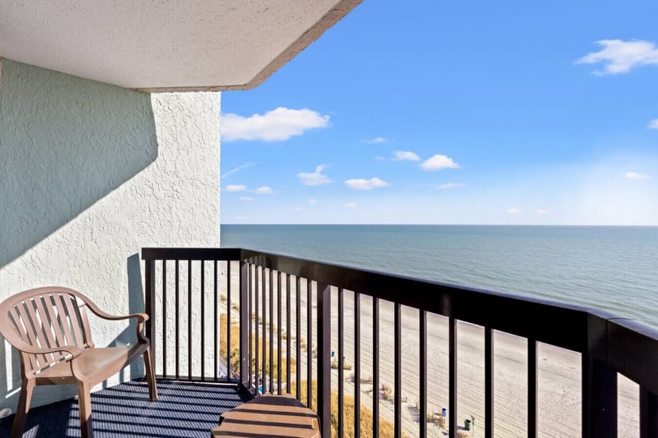 Direct oceanfront end-unit balcony offering resort pool views and sweeping panoramic vistas of the Atlantic Ocean and Myrtle Beach skyline. The perfect private spot to enjoy sunrise, sea breezes, and relaxing coastal moments.