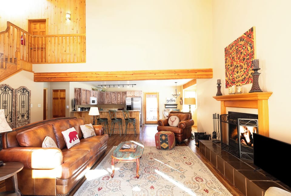 Sink into buttery leather sofas by your crackling fireplace, while rustic wood beams and mountain charm create the perfect alpine retreat atmosphere.