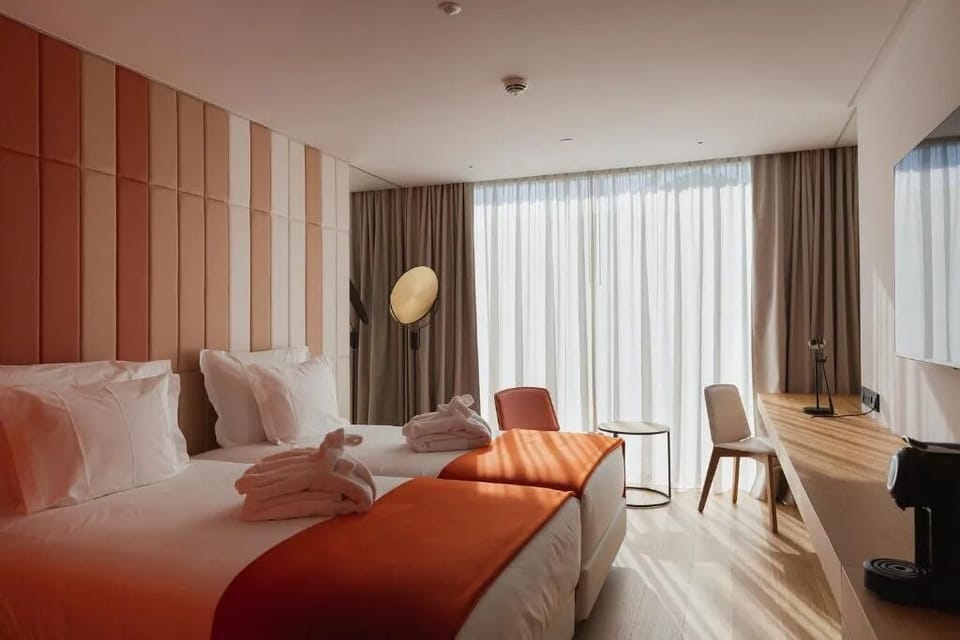 Sink into cozy beds as golden light fills the room.