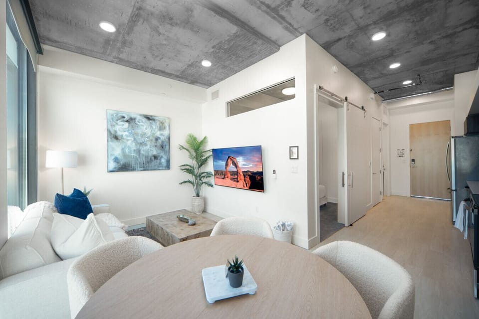 Luxury living room on the 10th floor with amazing views of downtown and mountains. Local original art and a 65” Roku tv.