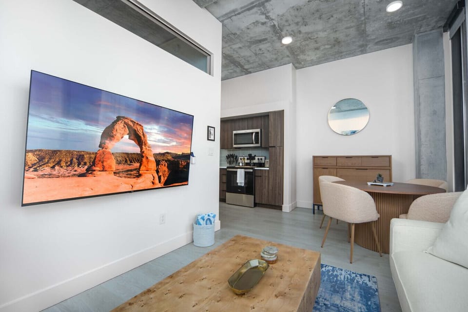 Luxury living room on the 10th floor with amazing views of downtown and mountains. Local original art and a 65” Roku tv.