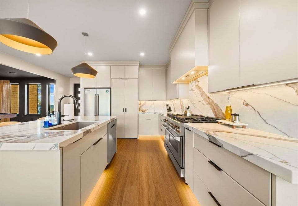 A sleek view of the kitchen that shows off the spacious counters and bright finishes, giving you all the room you need for snacks, meals, and everything in between.