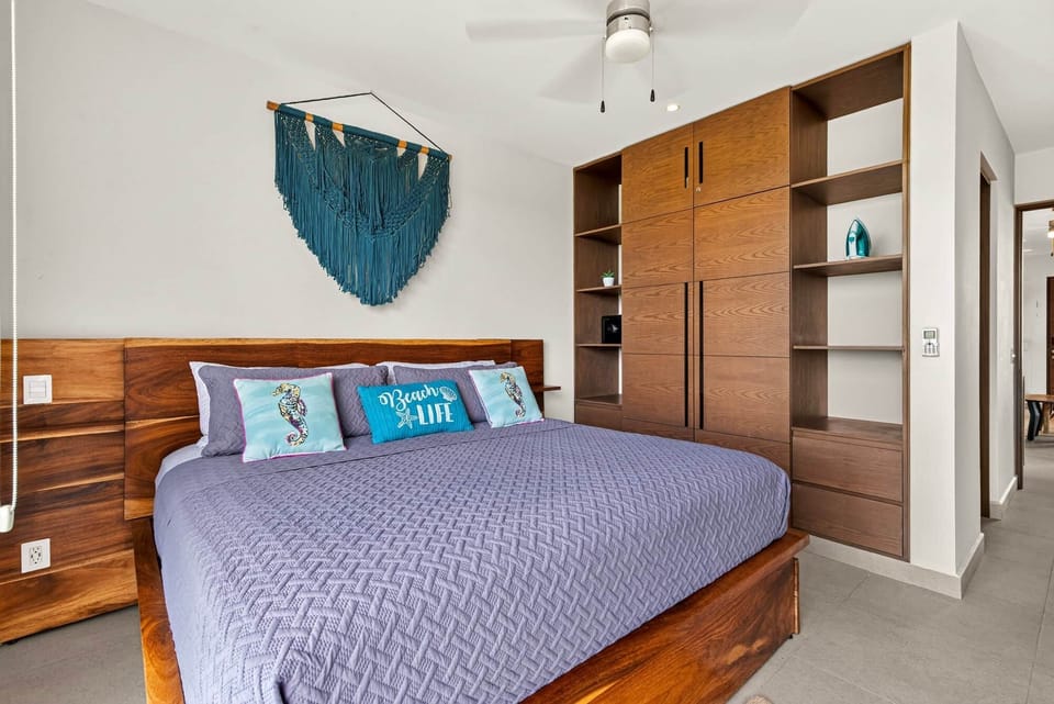 Main bedroom with king bed, smart TV, full wardrobe, secure safe, and a private en-suite bathroom.