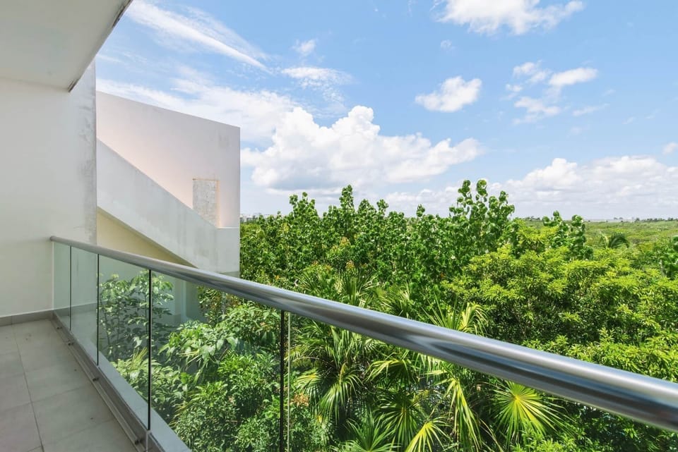 Both bedrooms open to a private balcony with fresh Caribbean breezes and lush Akumal jungle views.