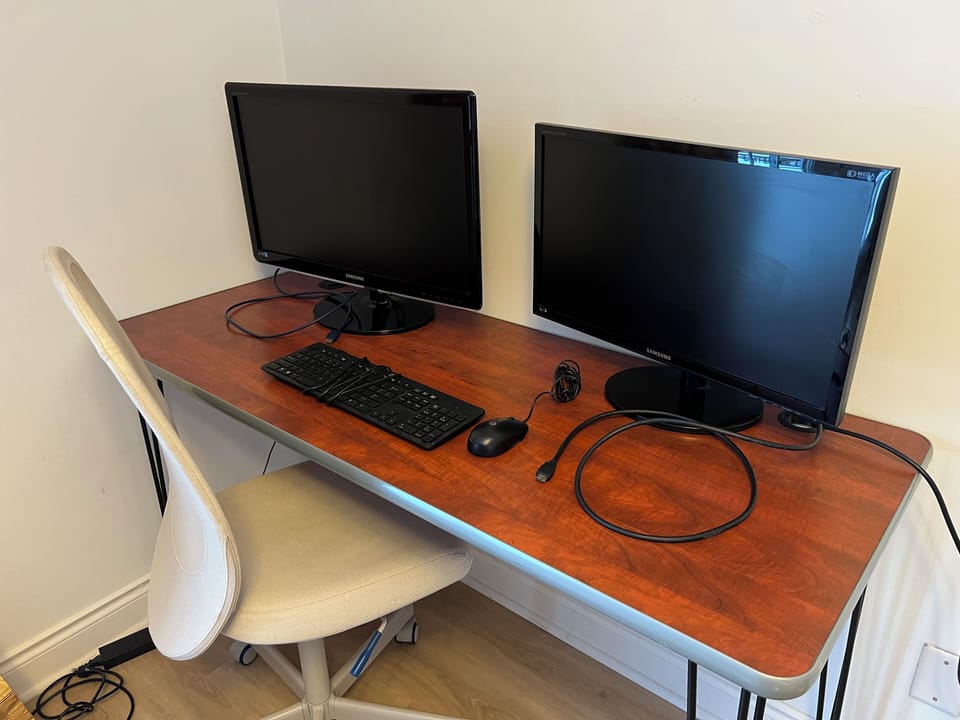 Two flat screen monitors, a mouse, a keyboard, and HDMI cable for each monitor.