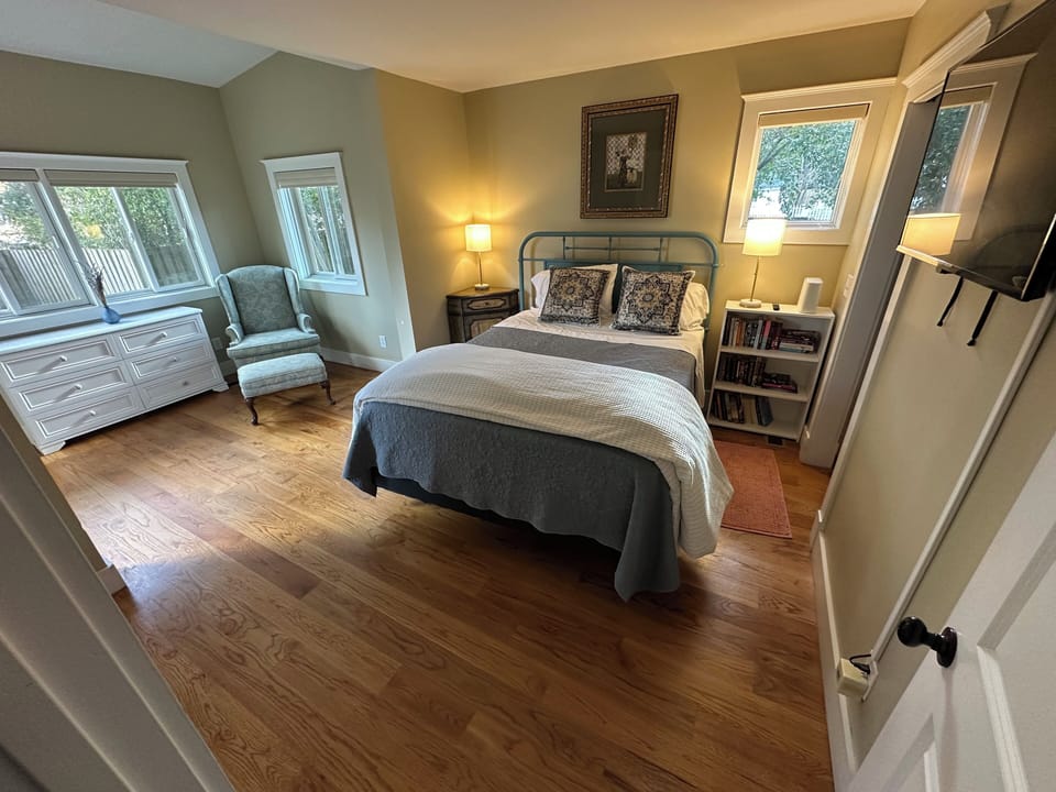Downstairs bedroom. Queen. Sitting area. Connects to bathroom has TV and closet.