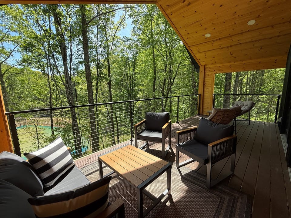 Covered upper deck at Sherwood — outdoor seating, wooded views, direct access from the main floor