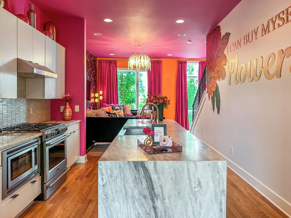 Kitchen – Second Floor: Kitchen with fridge, oven, microwave, and bar seating