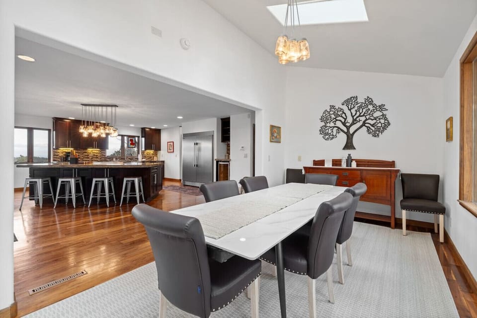 This angle highlights the excellent flow from the elegant dining space directly into the fully equipped, modern kitchen area.