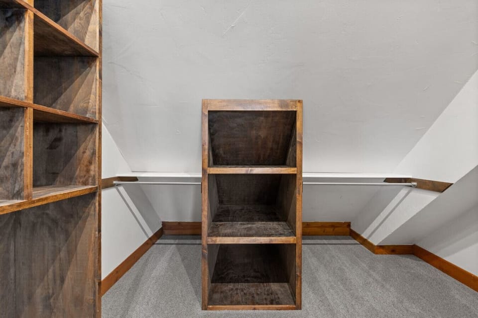 A cozy bathroom corner with wooden shelving and clean design brings warmth and simplicity to the space.
