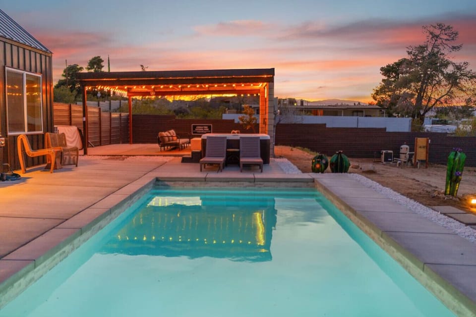 This is where you end up at sunset. New pool, open desert, mountain silhouettes on the horizon. Sol + Shadow was built for exactly this kind of evening.