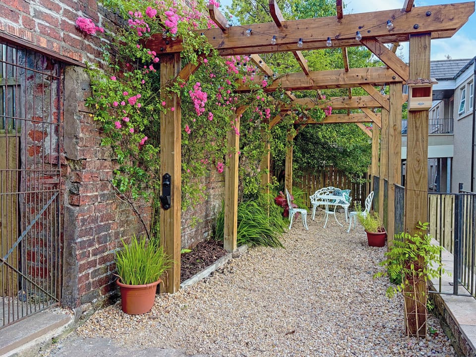 Pergola in back garden with seating area | 2 The Langhouse, Inverkip, near Greenock