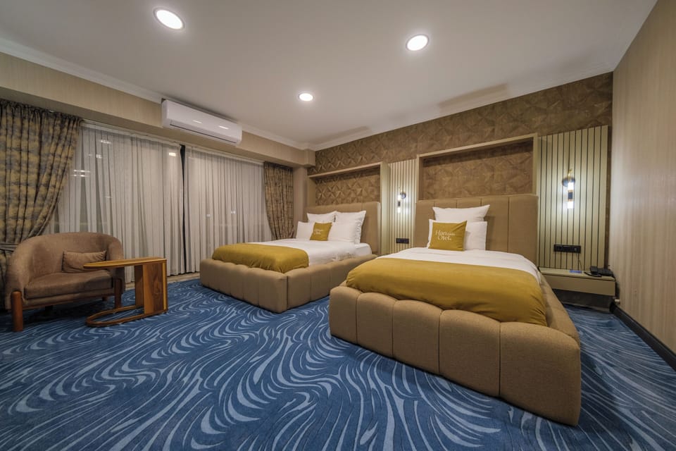 Deluxe Triple Room, Garden View | Premium bedding, in-room safe, desk, laptop workspace
