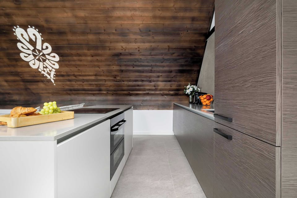 The sleek design of the kitchenette blending seamlessly with the living area.
