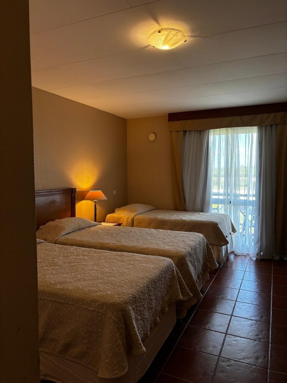 Standard Triple Room, Garden View | Minibar, in-room safe, blackout drapes, soundproofing
