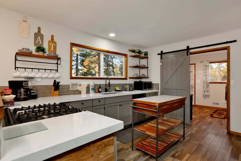 Fully equipped cabin kitchen with ample cabinetry, stove, fridge, microwave, and coffee maker—perfect for cooking meals, morning coffee, and feeling right at home on your stay.