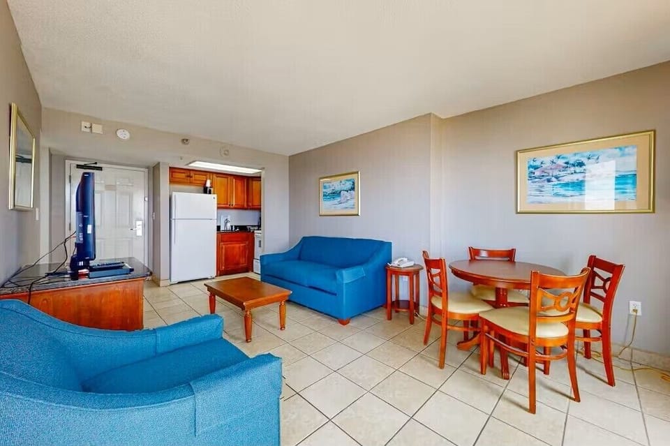 Open-concept condo with kitchen and ocean-view balcony