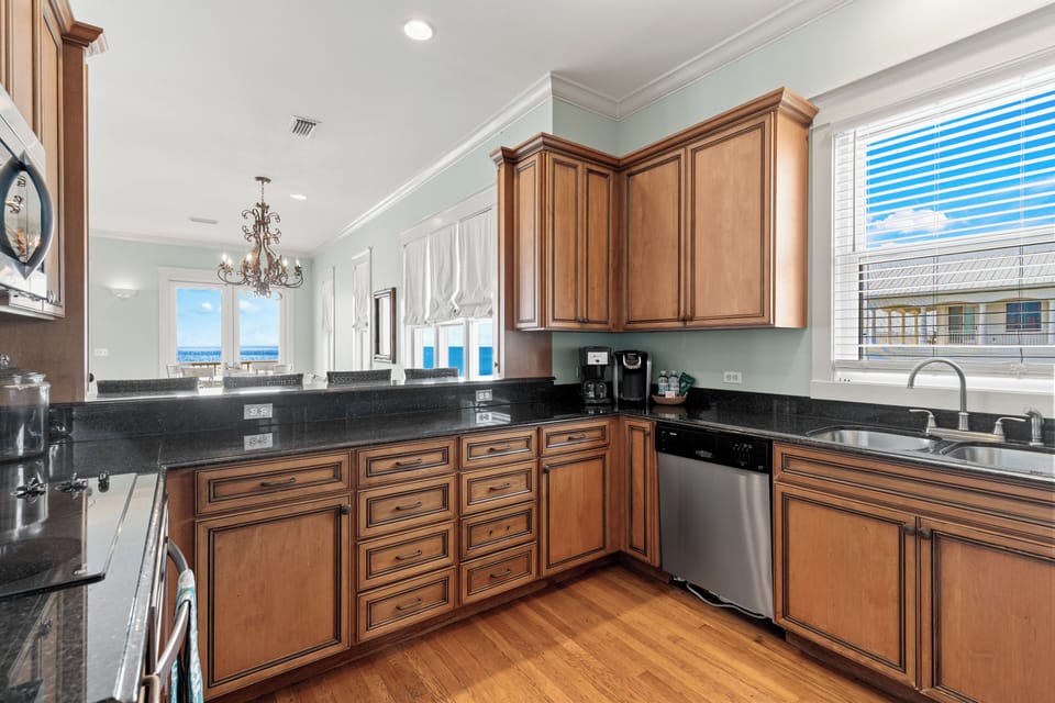 Your spacious kitchen features warm wood cabinetry, granite counters, and stainless appliances - perfect for cooking memorable meals together.