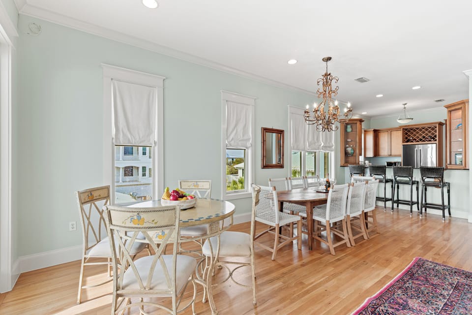 Gather around elegant dining spaces where morning coffee flows into evening feasts, all bathed in natural light from oversized windows.