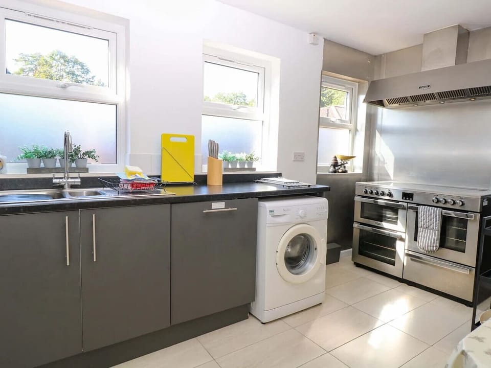 Kitchen corner with range cooker, counters, and appliances.