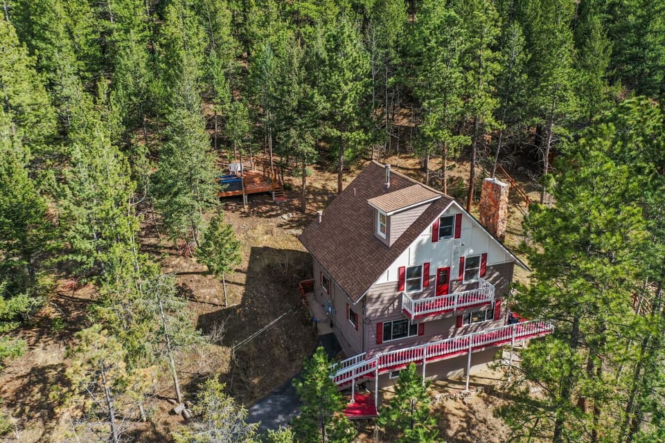 A serene forest getaway offering room to unwind and beautiful views from the elevated deck.