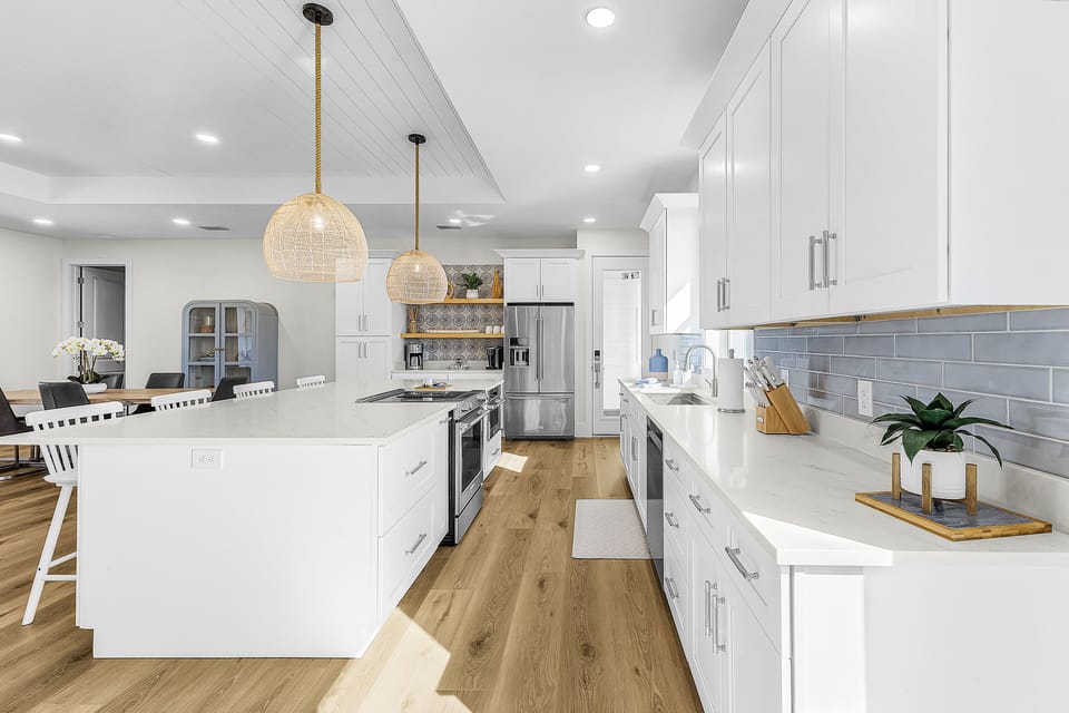 Kitchen with range, cook top, under counter microwave, fridge and dishwasher