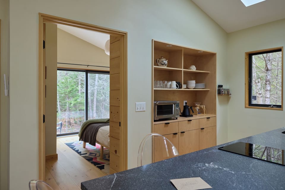 The private bedroom is right off the kitchen which features custom cabinets.