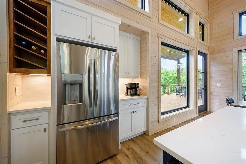 Gourmet Kitchen: Modern stainless appliances & large windows invite nature into your culinary adventures!