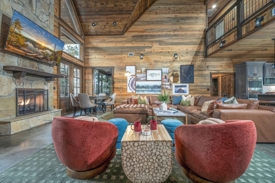 Living Room: Relax in style with vibrant seating, a stone fireplace, and stunning nature views!