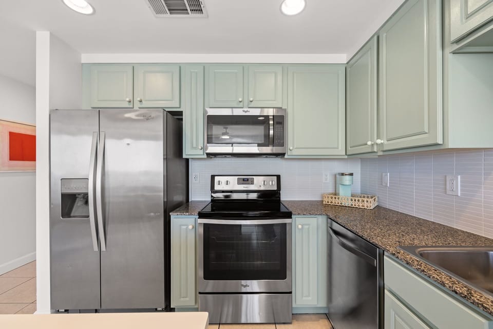 The kitchen is equipped with refrigerator, water dispenser, microwave, stove/ oven and dishwasher.  