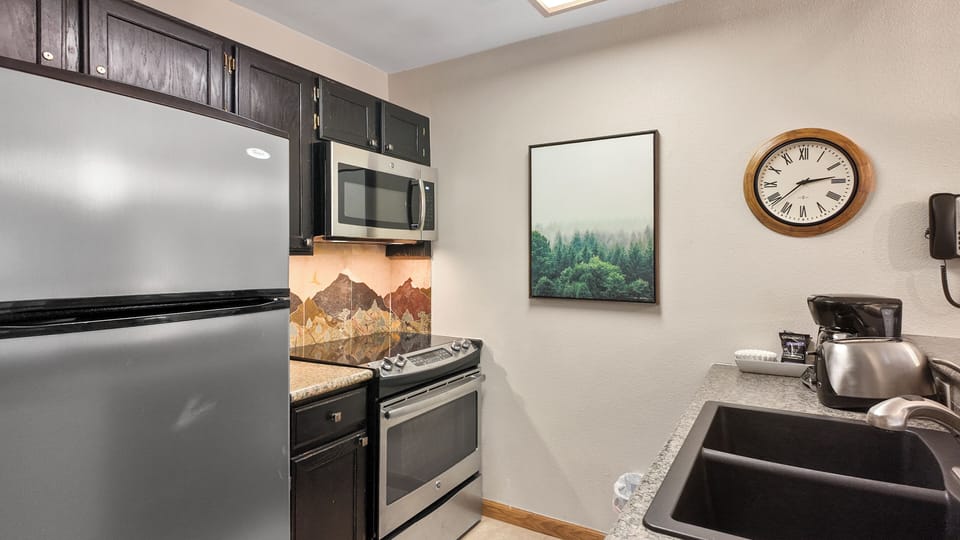 Full kitchen with stainless appliances ready for home cooking and dining.