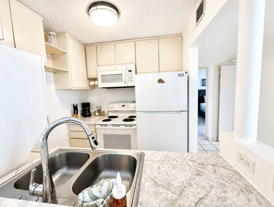 Whip up delicious meals in this fully-equipped kitchen, complete with a microwave, refrigerator, stove, oven, and everything else you need for a hassle-free stay.