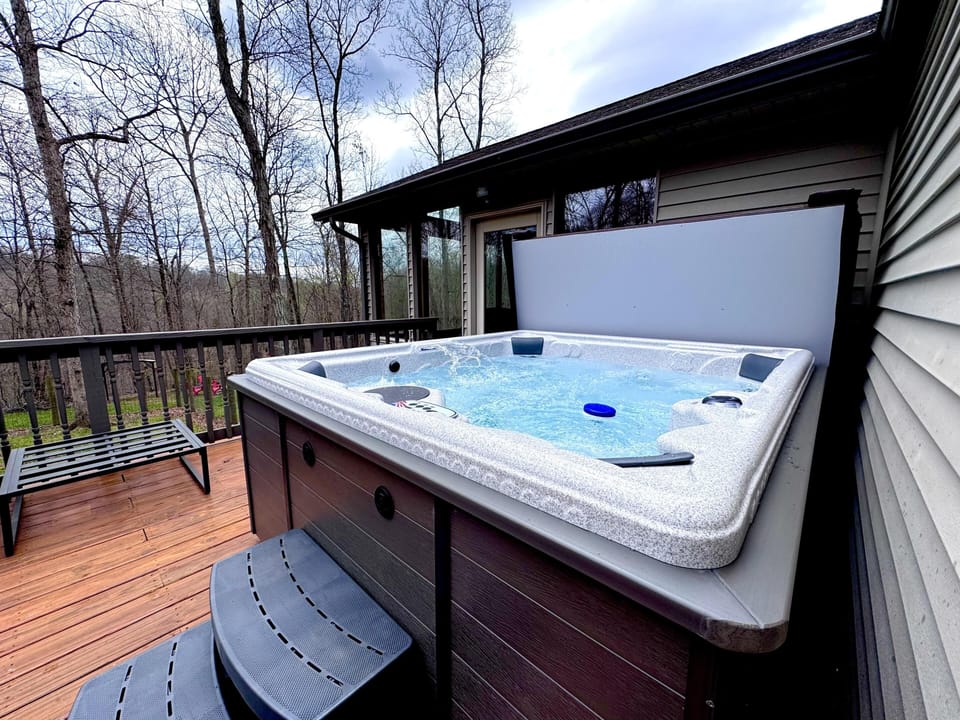 Relax in the spacious outdoor hot tub on the deck