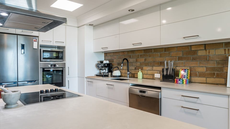 Spacious kitchen with stainless steel appliances and ample storage