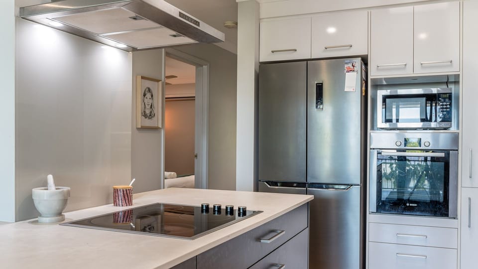 Kitchen island and cooking zone with built-in oven and fridge