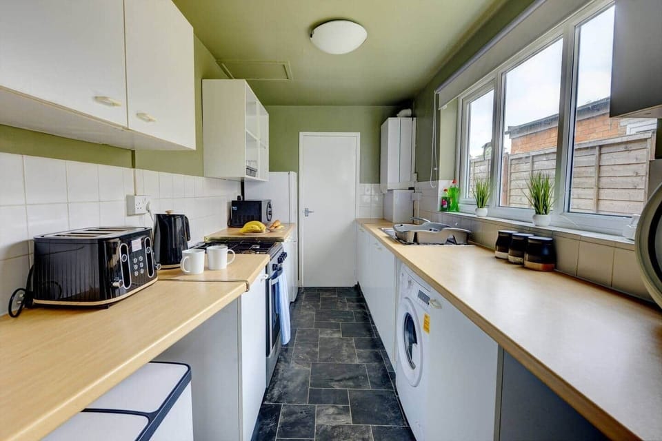 The kitchen has a contemporary and stylish aesthetic that seamlessly integrates with the overall ambiance of the house. Clean lines, minimalist decor, and high-quality materials create an inviting space that is both visually striking and practical.