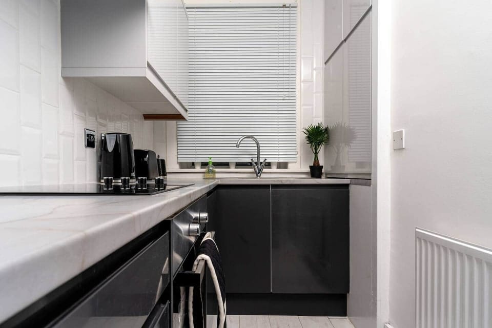 The kitchen has a contemporary and stylish aesthetic that seamlessly integrates with the overall ambiance of the house. Clean lines, minimalist decor, and high-quality materials create an inviting space that is both visually striking and practical.